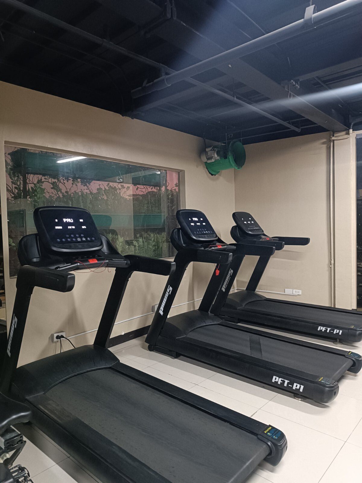 Cardio area with commercial treadmills at Niq's Fitness Gym in Quezon City with view outside